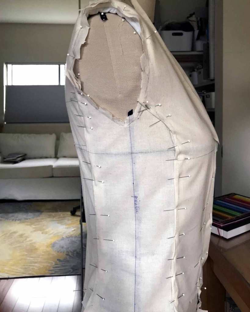 Side view of a bodice drape with side panel. Lots of pins