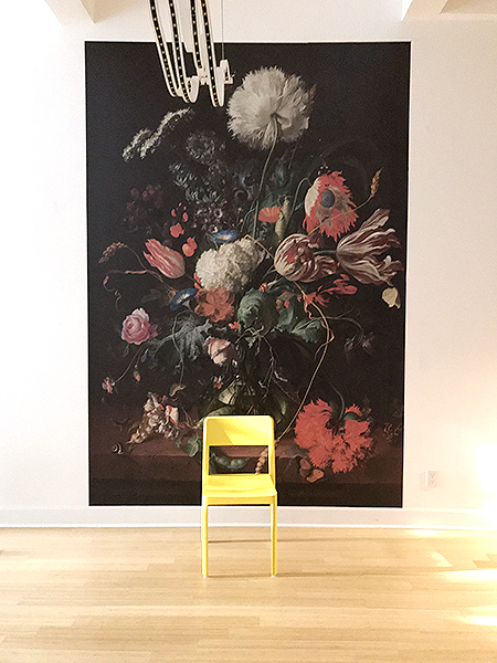 Installed - Wall sized Dutch painting mural, yellow chair and modern curvy chandelier inspired by Droog Hotel Library